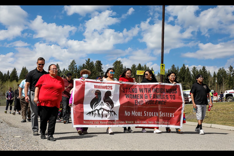 People march from the Chiniki Smitty's parking lot to the Chiniki Lake Road overpass to honour missing and murdered Indigenous women, girls, and two-spirit people (MMIWG2S) at Red Dress Day at the Chiniki Smitty's parking lot in Mînî Thnî  (Morley) on Friday (May 5). JUNGMIN HAM RMO PHOTO