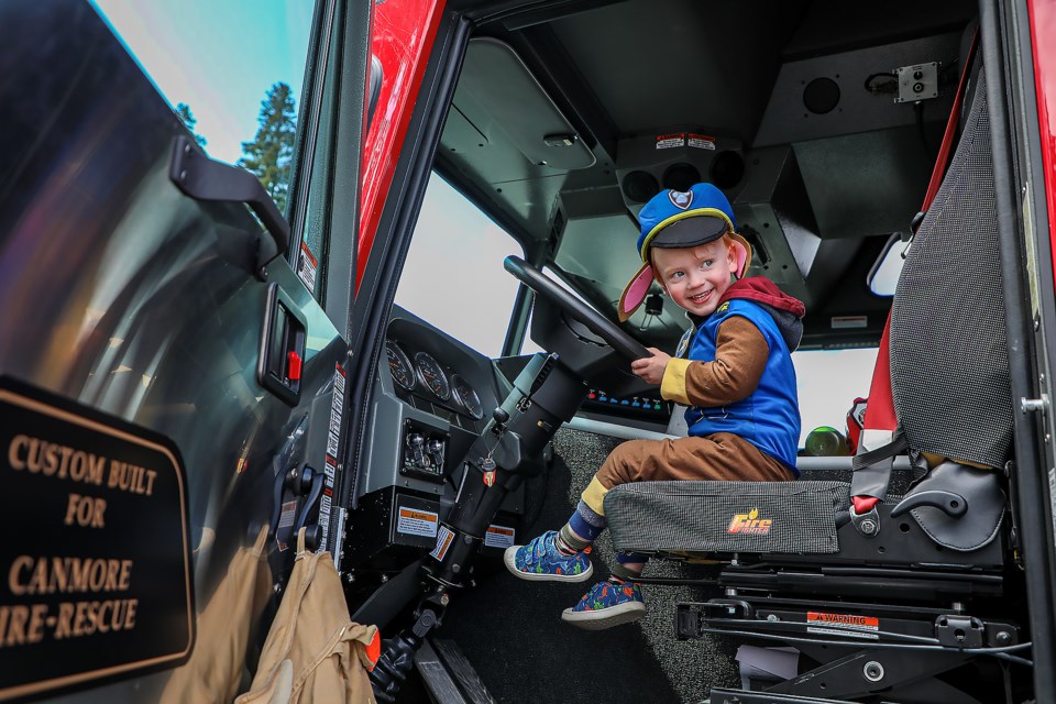 Eomerson Nasset, 3, amuses himself by pretending to drive a fire truck at Disaster Readiness Day at the Banff train station public parking lot on Sunday (May 7). JUNGMIN HAM RMO PHOTO