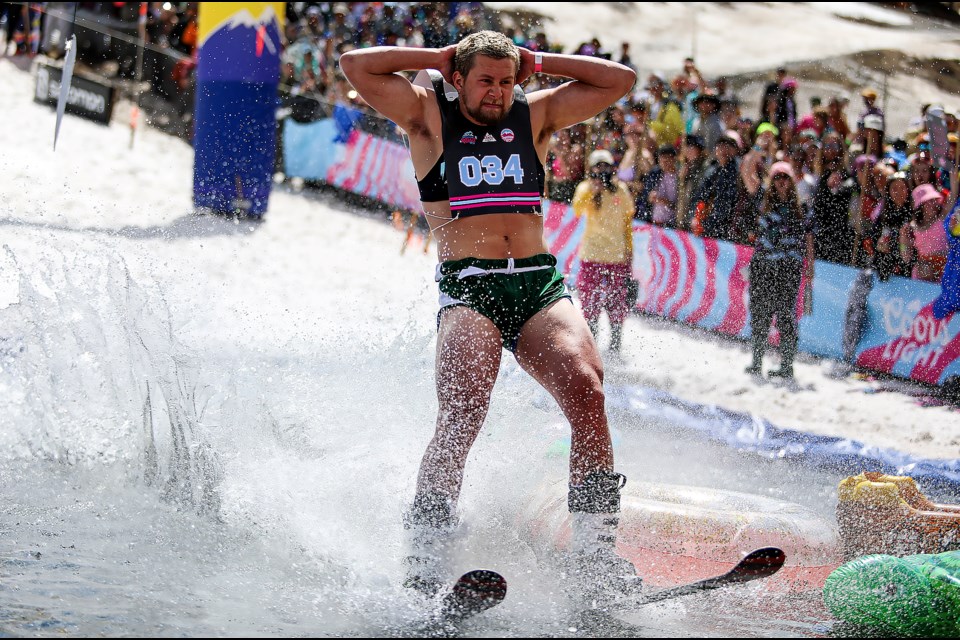 Daniel Harrison poses as a bodybuilder and makes a splash during the 93rd annual Slush Cup event at Banff Sunshine Village Ski Resort on Monday (May 22). JUNGMIN HAM RMO PHOTO