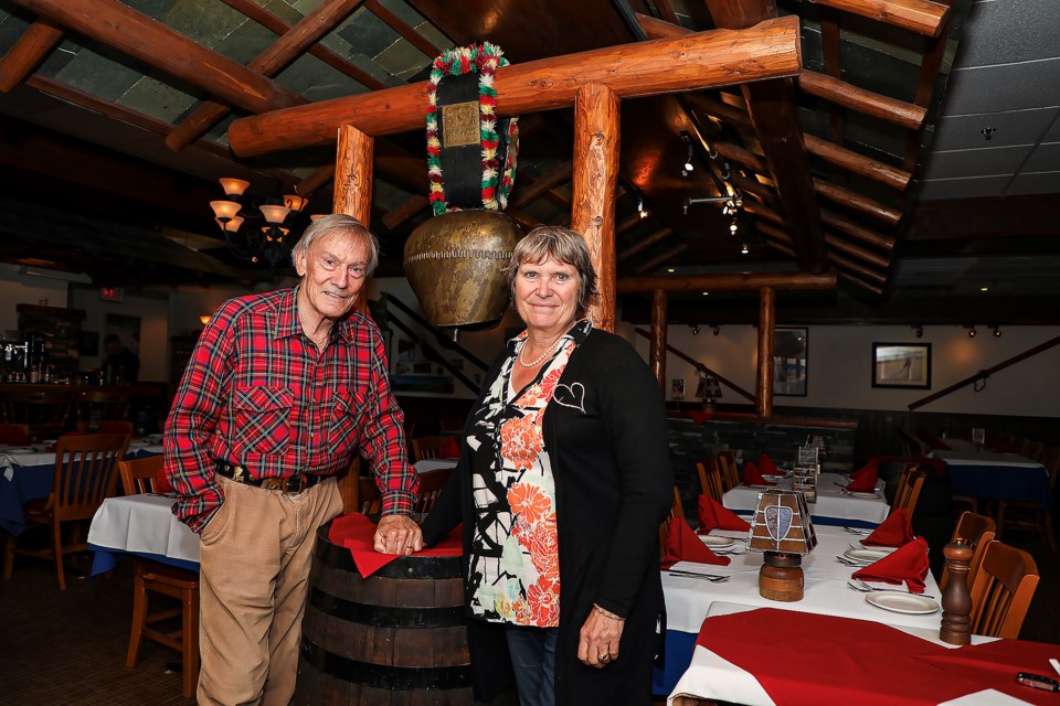 Ticino Swiss-Italian Restaurant's Erwin Widmer, left, and Lorraine Widmer-Carson pose under the Swiss cowbell in the restaurant on Banff Avenue on Thursday (May 25). JUNGMIN HAM RMO PHOTO