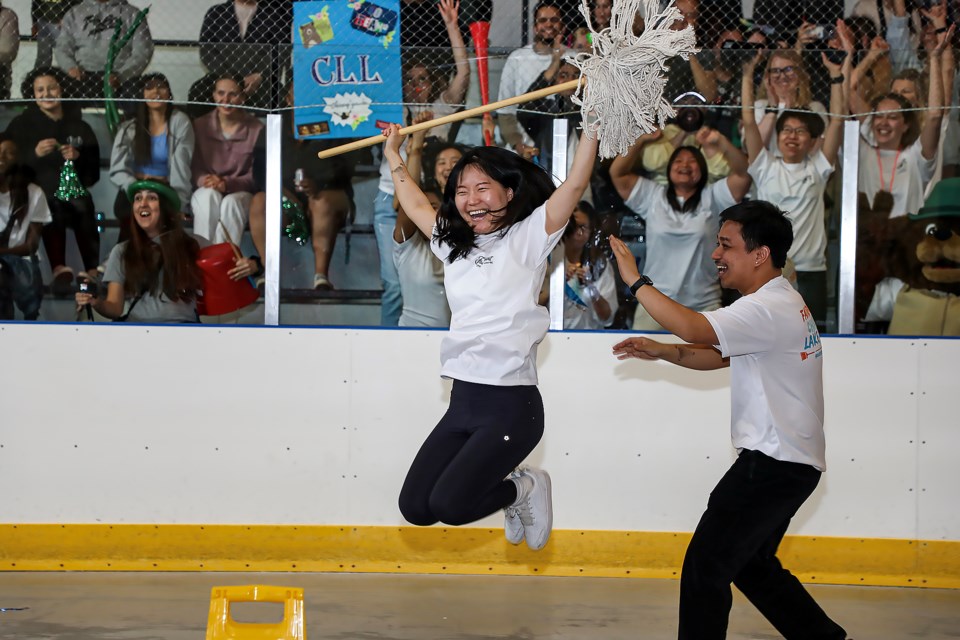 Soomin Lee of the Fairmont Cháteau Lake Louise jumps when she gets a good score after finishing mop race during the 8th Annual Banff Lake Louise Housekeeping Olympics at the Fenlands Banff Recreation Centre on Thursday (June 1).JUNGMIN HAM RMO PHOTO