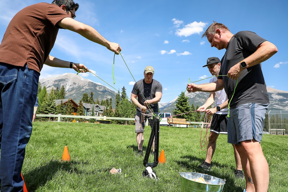 Team Squirrel works together to catch the doll in the mini-Olympics team building activity hosted by White Mountain Adventures at Millennium Park in Canmore on Thursday (June 8). JUNGMIN HAM RMO PHOTO