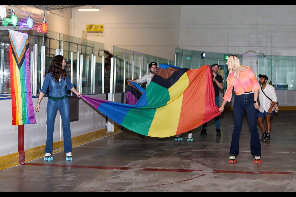 Roller skaters carry a large rainbow flag at the Banff Pride Roller Disco at the Fenlands Banff Recreation Centre on Friday (June 9). JUNGMIN HAM RMO PHOTO