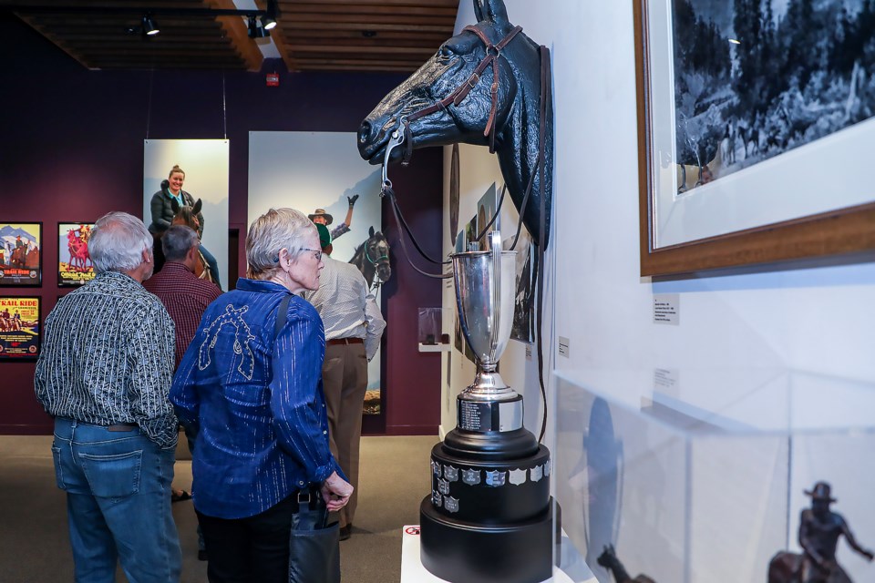 Trail Riders of the Canadian Rockies' Judy Fleetham, right, appreciates the exhibits at the summer exhibition opening "Celebrating 100 Years: Trail Riders of the Canadian Rockies" at the Whyte Museum in Banff on Friday (June 16). JUNGMIN HAM RMO PHOTO