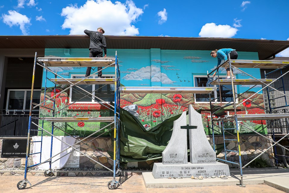 Jillian Amatt, right, and Chris DeCap unveiled the mural, "Between the Poppies," which took more than 100 hours to complete at the Royal Canadian Legion Branch 3 Three Sisters in Canmore on Friday (June 23). JUNGMIN HAM RMO PHOTO