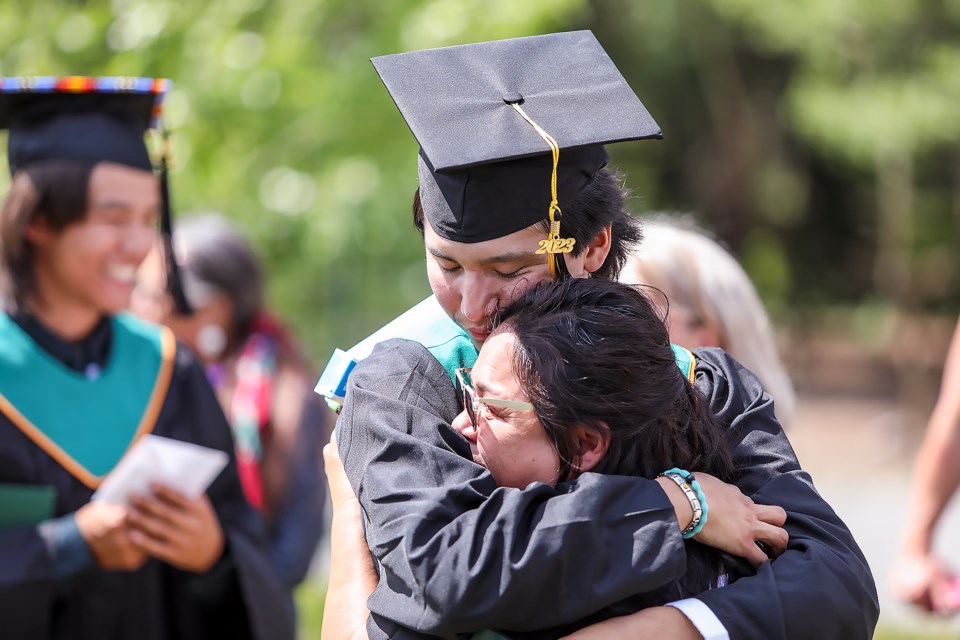 Peter Fox and his mother hug one another at the Canmore Collegiate High School graduation ceremony in Canmore on Thursday (June 29). JUNGMIN HAM RMO PHOTO