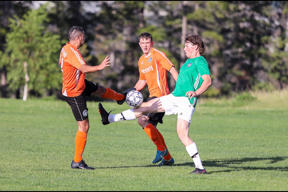 Rundle FC's Manuel Riquelme, left, and Banff Pump and Tap's Simon Norgrove fight for the ball during a match in the Bow Valley Soccer League at Our Lady of the Snows Catholic Academy Field in Canmore on Thursday (June 29). JUNGMIN HAM RMO PHOTO