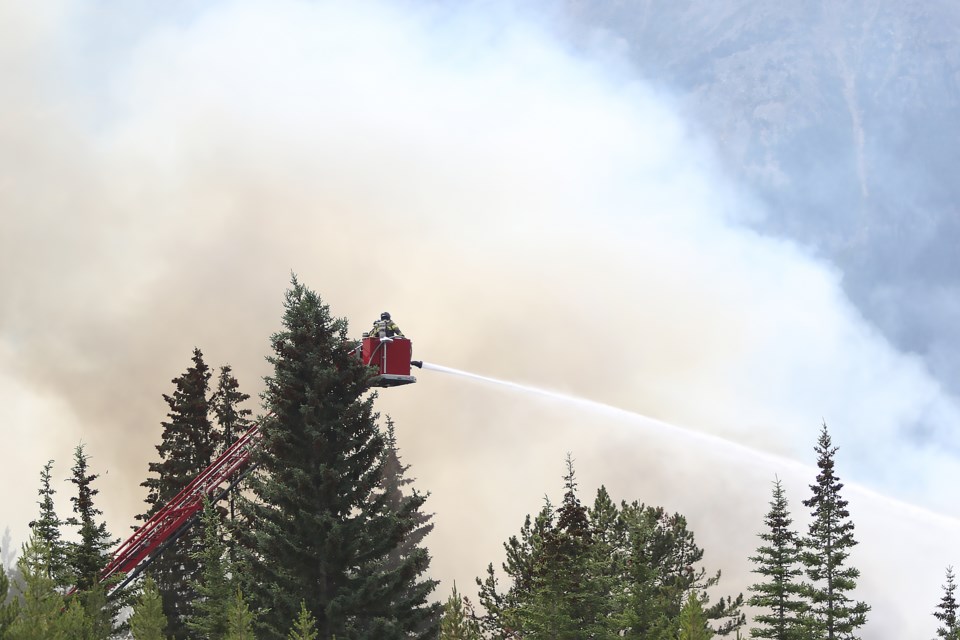 Firefighters battle a massive blaze at the Skiing Louise-owned Charleston Residence on Village Road in Lake Louise on Monday (July 3). GREG COLGAN RMO PHOTO