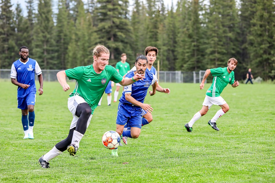 Banff Pump and Tap's Connor McArdle, left, turns on the jets to get past Canmore United's Hector Navaro during a match in the Bow Valley Soccer League at Millennium Field in Canmore on Thursday (July 6). JUNGMIN HAM RMO PHOTO