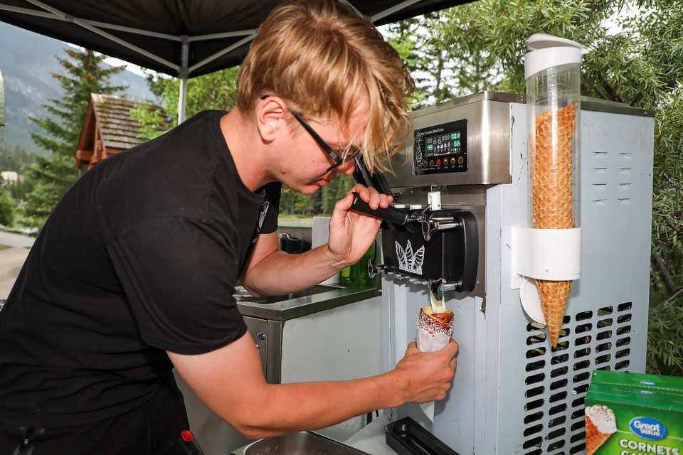 Alex Lizler from the Czechia puts ice cream in a traditional Czech and Hungarian bread chimney cone at the Banff Farmers Market on Wednesday (July 12). JUNGMIN HAM RMO PHOTO