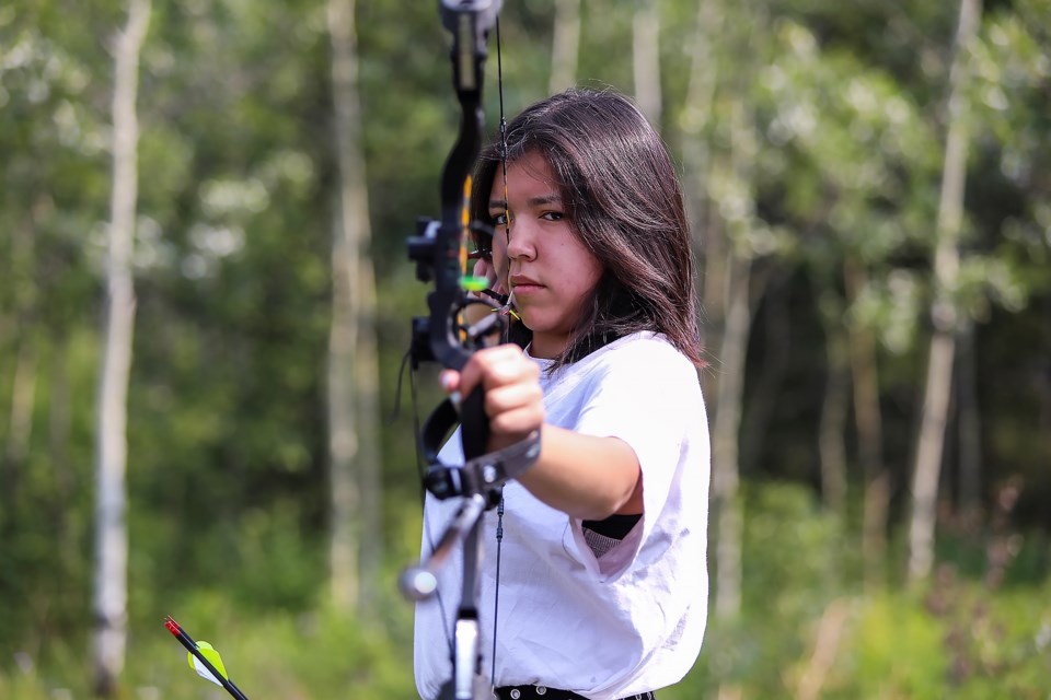Compound archery athlete Nikkita Beaver-Ear, who qualified in archery for the North American Indigenous Games, practices at her home in Mînî Thnî (Morley) on Friday (July 14). JUNGMIN HAM RMO PHOTO