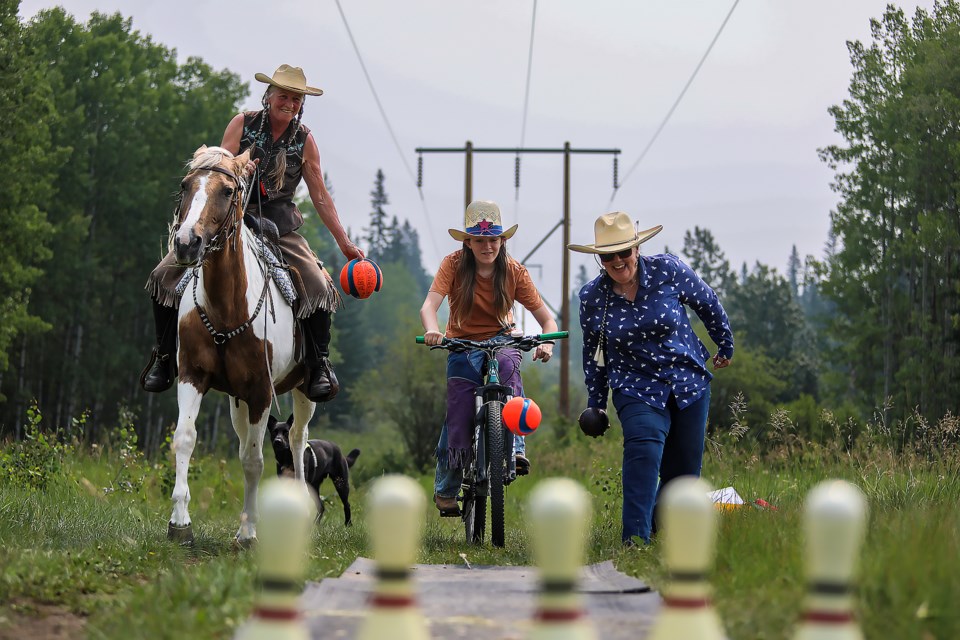 Wendy Bush, left, Maggie Chambers, centre, and Cheryl McTrowe bowl together during the inaugural Share the Trails event at Indian Flats in Canmore on Saturday (July 15). JUNGMIN HAM RMO PHOTO