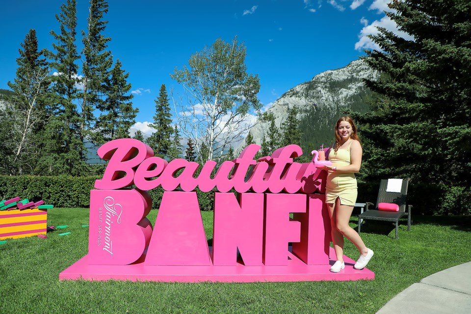 Banff's Mariah Miller poses with the Rundle Bar's award-winning signature blue gin, crafted by Fairmont Regional Mixologist and Diageo World Class Canada Top 3 Bartender Sam Clark, at Fairmont Banff Springs' Banffchella on Sunday (July 16). JUNGMIN HAM RMO PHOTO