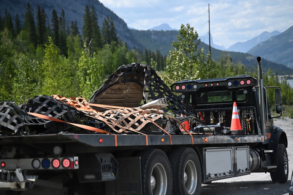 A flat bed truck halls debris from a crashed airplane after an Alpine helicopter flew it out of the crash site near Kananaskis on Saturday (July 29). MATTHEW THOMPSON RMO PHOTO