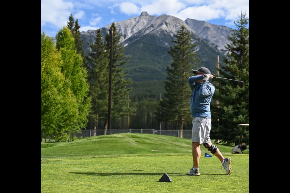 Simon Reid watches his drive at the Canmore Golf and Curling club in an UpSwing golf event on Friday (Aug. 11). MATTHEW THOMPSON RMO PHOTO