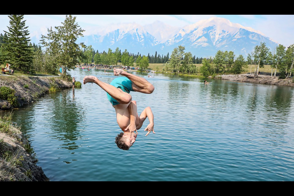 Gavin Caskey from Olds performs a back flip into Quarry Lake in Canmore on Thursday (Aug.17). JUNGMIN HAM RMO PHOTO