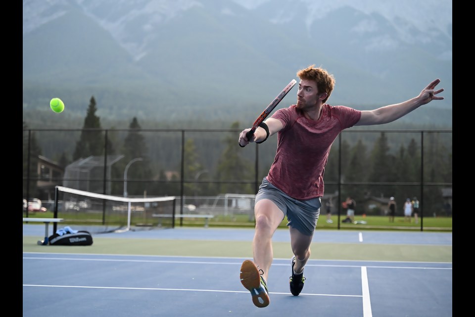 Ewen Clark lunges for the ball during the finals of a singles championship match in Canmore at the Lions Park tennis courts on Sunday (Aug. 27). MATTHEW THOMPSON RMO PHOTO