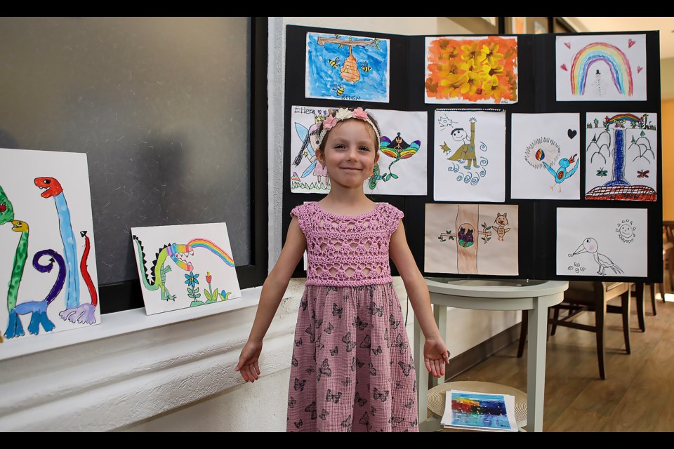 Artist Ellen Goudreau, 6, poses in front of her work at the Banff Mineral Springs Hospital fundraising event, The Art for Life Exhibition, at Mineral Springs Hospital in Banff on Tuesday (Aug. 29). JUNGMIN HAM RMO PHOTO 