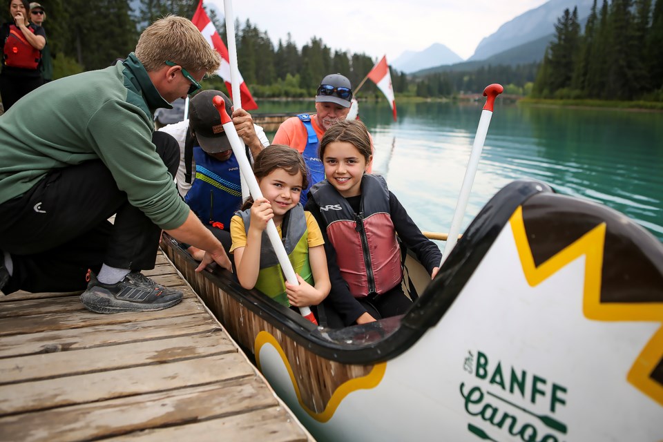Frida Karlos 7, left, and Fawn Karlos, 10, prepare for Big Canoe Races during the Canoe for a Cause 2023 event in Banff National Park on Wednesday (Aug. 31). JUNGMIN HAM RMO PHOTO 