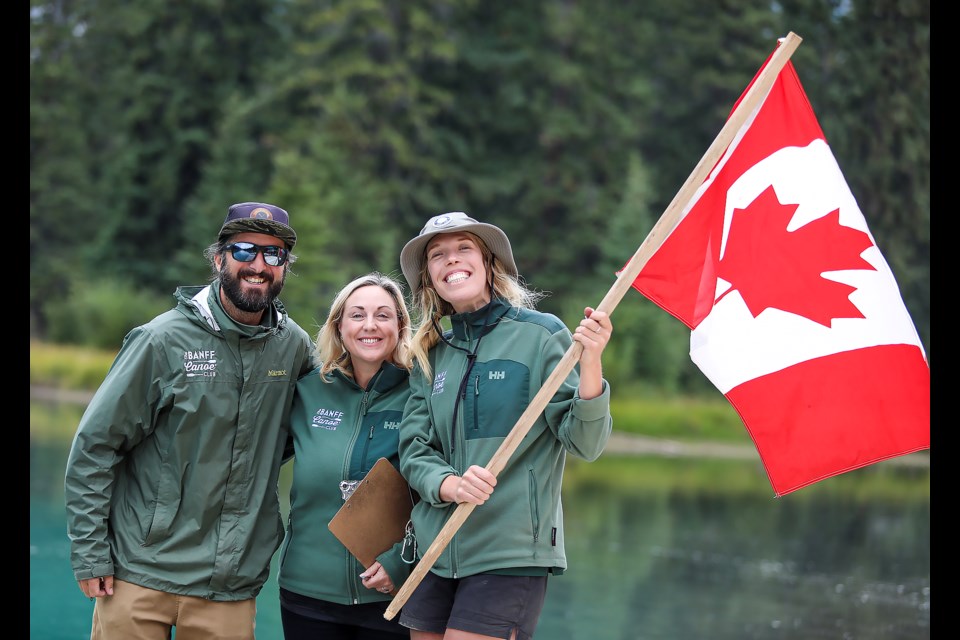 Banff Canoe Club's Austin Kosslyn, left, Tanya Price, centre, and Lucy Congreve pose at the Big Canoe Races finish line during the Canoe for a Cause 2023 event in Banff National Park on Wednesday (Aug. 31). The Canoe for a Cause 2023 event raised $12,000 for the Banff Canmore Community Foundation. JUNGMIN HAM RMO PHOTO 
