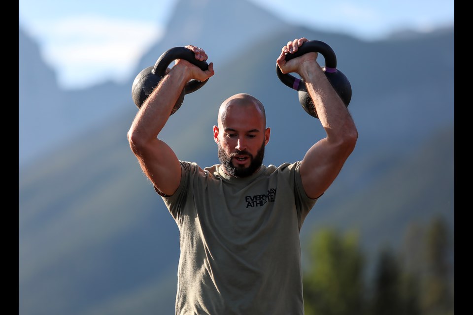 Team Hustle and Muscle's Graham MacDonald does squats with 54-pound kettlebell at the 9th annual Rocky Mountain Crusher at the Canmore Nordic Centre on Saturday (Sept. 2). JUNGMIN HAM RMO PHOTO 