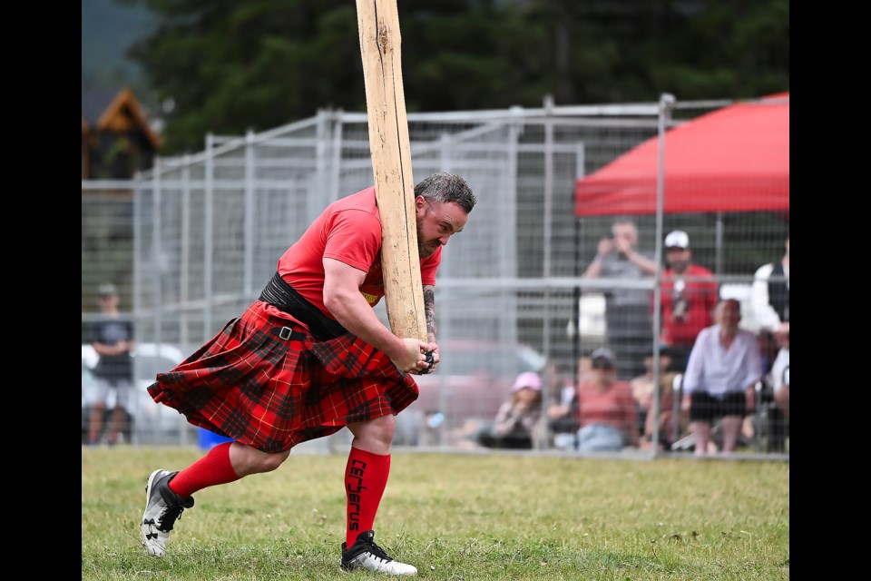 Dylan Cameron runs with a caber before attempting to flip it during the heavy sports event at the Canmore Highland Games on Sunday (Sept. 3). MATTHEW THOMPSON RMO PHOTO