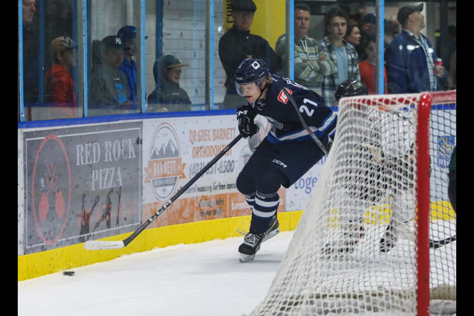 Canmore Eagles' Hunter Burgeson battles with an Okotoks Oilers player for possession of a loose puck during the season home opener against the Okotoks Oilers at the Canmore Recreation Centre on Friday (Sept. 15). JUNGMIN HAM RMO PHOTO 
