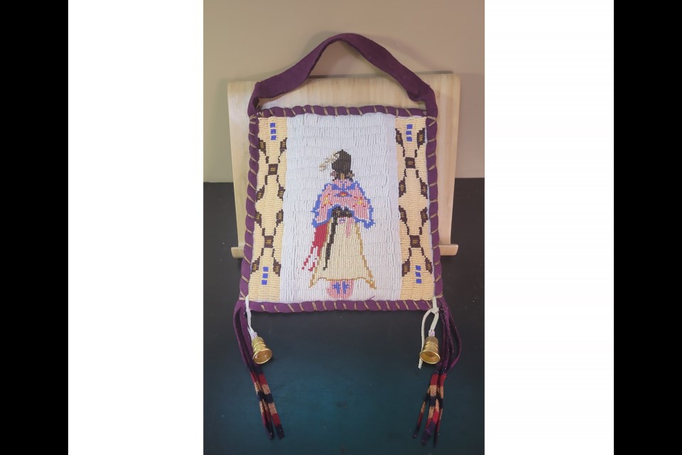 A beaded purse with an image depicting an Indigenous woman wearing regalia, created by Teresa Snow for Wagaichibi Îhnuthe: The Dance Regalia of the Îyârhe Nakoda, at the Canmore Museum from Thursday (Sept. 21) to Jan. 18, 2024.

PHOTO COURTESY OF TERESA SNOW