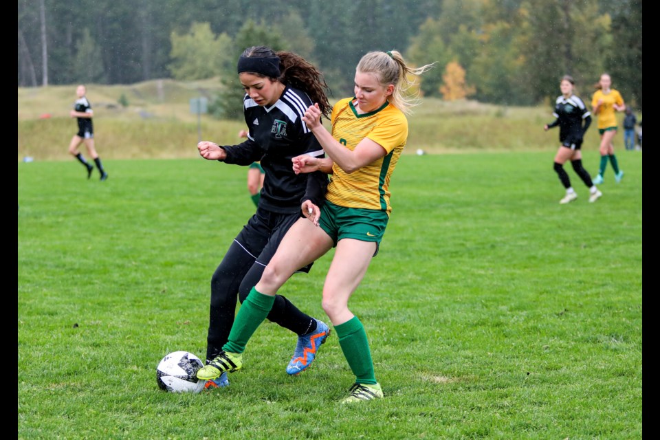 Canmore Wolverines Kaisa Lemyre, right, and the Holy Trinity Knights player fight for the ball during the home opener game at Millennium Park in Canmore on Wednesday (Sept. 20). The Knights won 3-1. JUNGMIN HAM RMO PHOTO  

