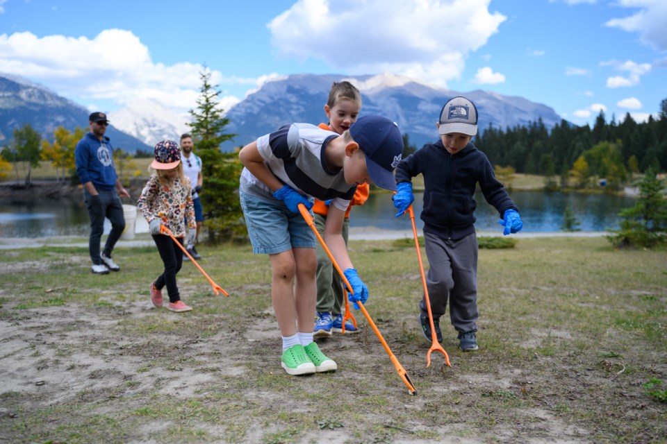 Milo Miller picks up garbage at Quarry Lake in Canmore on Sunday (Sept. 24). The cleanup was a collaboration between Canmore Municipal Enforcement and the Biosphere Institute of the Bow Valley. MATTHEW THOMPSON RMO PHOTO