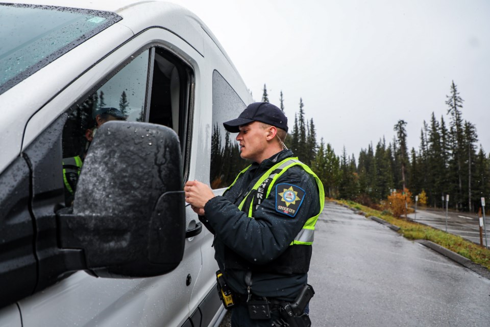 Highway patrol sheriff officer Jorden Hill inspects a commercial vehicle to ensure it is in good working order and in compliance with all provincial and federal legislation at Moraine Lake on Sept. 28. JUNGMIN HAM RMO PHOTO