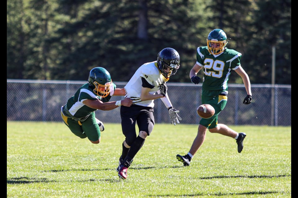 Canmore Wolverines Prince Biado makes a tackle against Carstairs Kodiaks running back during a game at Millennium Park in Canmore on Saturday (Oct. 7). The Wolverines defeated the Kodiaks 30-18. JUNGMIN HAM RMO PHOTO

