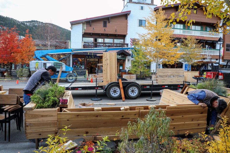 Trevor Ragan, left, and Wayne Ragan remove on-street displays and patios on Banff Avenue in October. Council has decided to continue with the pedestrian zone on an annual basis.
Oct. 13. JUNGMIN HAM RMO PHOTO