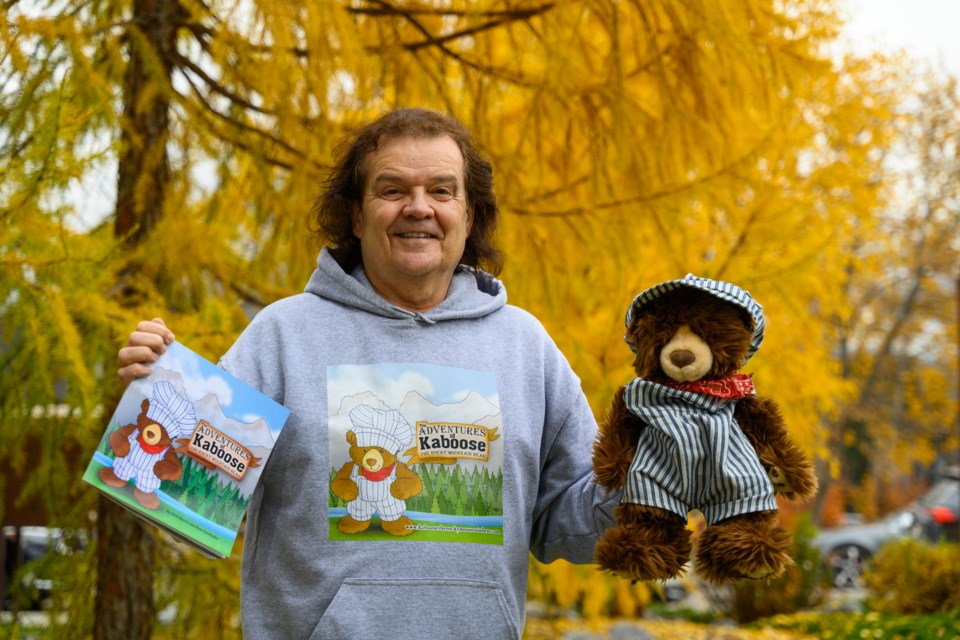 Rick Harris poses with his newly released children's book and the mascot, Kaboose, in Canmore on Thursday (Oct. 12). MATTHEW THOMPSON RMO PHOTO