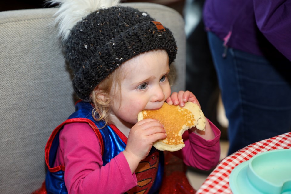 Amira Fountain, 2, enjoys pancakes made by Banff firefighters at the annual Fire Prevention Week pancake breakfast at the Banff Fire Hall on Saturday (Oct. 14). JUNGMIN HAM RMO PHOTO