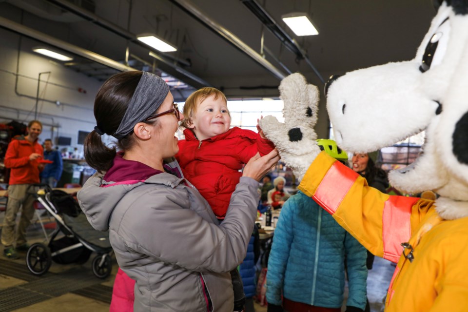 Kendra Carter and Clara Carter give a high five to Sparky the fire dog at the annual Fire Prevention Week pancake breakfast at the Canmore Fire Hall on Saturday (Oct. 14).JUNGMIN HAM RMO PHOTO