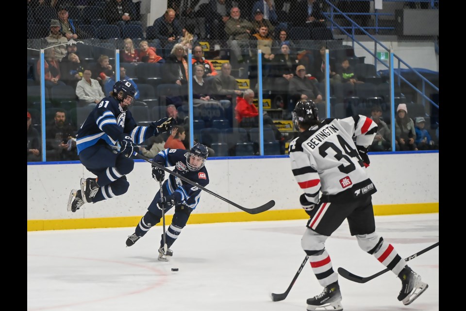 Canmore Eagles Zach Coutu jumps over the puck as Casey Black takes a shot against the Whitecourt Wolverines in Canmore on Sunday (Oct. 15). The Canmore Eagles lost 0-7 against the Whitecourt Wolverines. MATTHEW THOMPSON RMO PHOTO