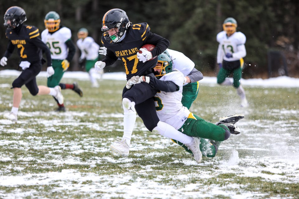 Canmore Wolverines Christoph LeClerc tackles the Olds Spartans running back at Millennium Park in Canmore on Saturday (Oct. 28). The Wolverines lost 49-20. JUNGMIN HAM RMO PHOTO