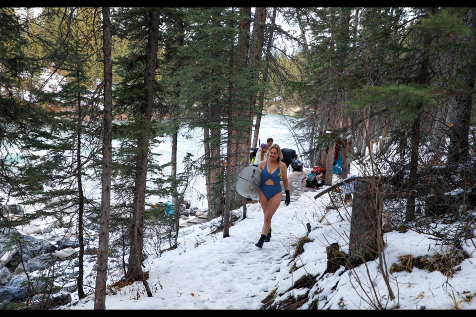 Canmore's Angela Knox hikes through the forest to gain access to ride the Mountain Wave at the near Canoe Meadows in Kananaskis Country on Friday (Nov. 3). JUNGMIN HAM RMO PHOTO