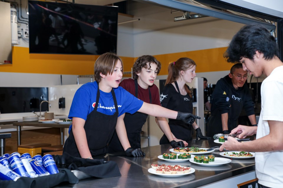 Grade 10 Laken Lambert, left, and Shea Vaugeois in the foods classroom explain the appetizers to the guests at the Banff Community High School's Fall Open House on Wednesday (Nov. 8). JUNGMIN HAM RMO PHOTO