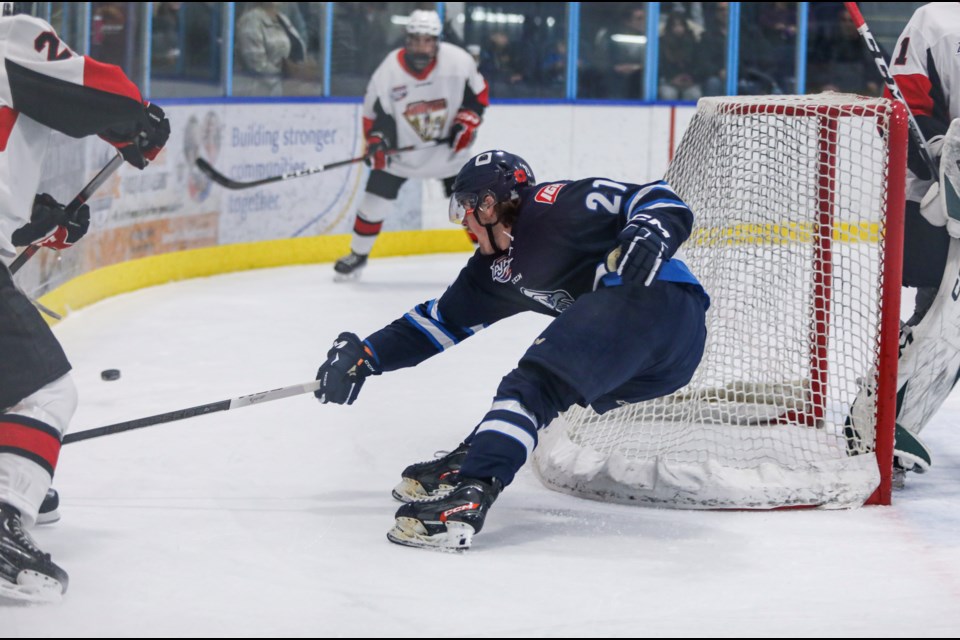Canmore Eagles Nathan Macpherson-Ridgewell battles for the puck against the Camrose Kodiaks at the Canmore Recreation Centre on Friday (Nov. 10). The Eagles beat the Kodiaks 4-2. JUNGMIN HAM RMO PHOTO 