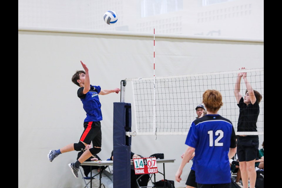 OLS Avalanche Hunter Arnone prepares to smash the ball against Langdon during the junior South Central Zone boys volleyball tournament at Our Lady of the Snows Catholic Academy in Canmore on Friday (Nov. 10). OLS Avalanche won the game 2-1. OLS finished eighth overall. JUNGMIN HAM RMO PHOTO