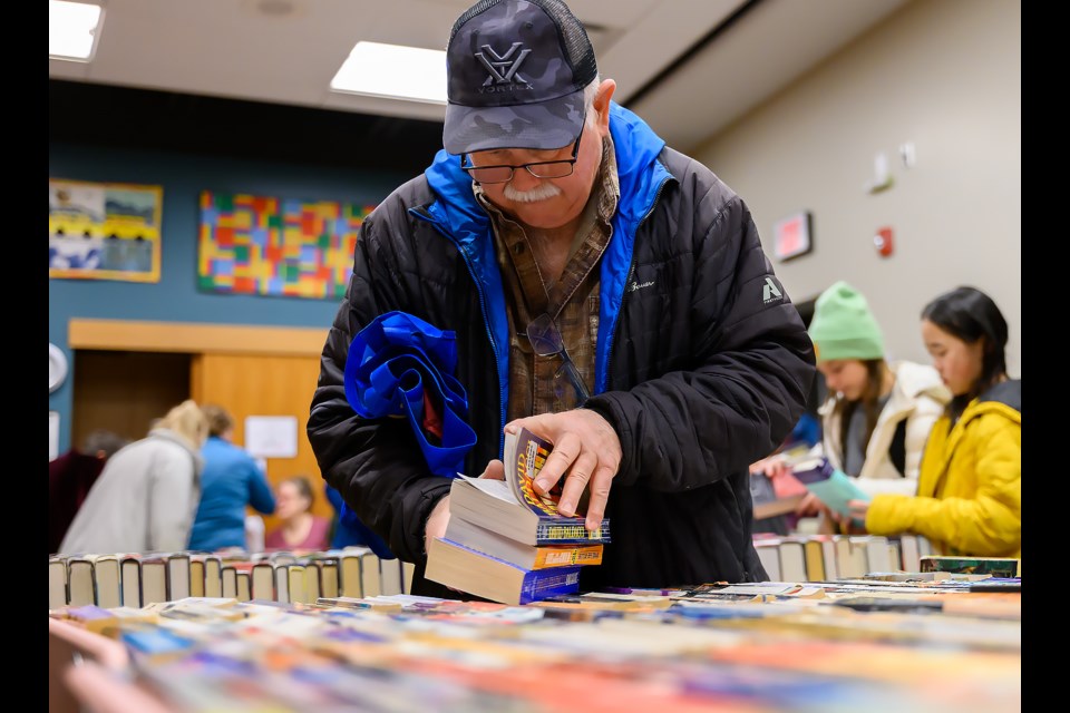 Stan Clarahan searches through books at the Friends of the Canmore Library book sale in Canmore at Elevation Place on Thursday (Nov. 16). Since 1993, friends has raised over half a million dollars to support the Canmore Public Library. MATTHEW THOMPSON RMO PHOTO