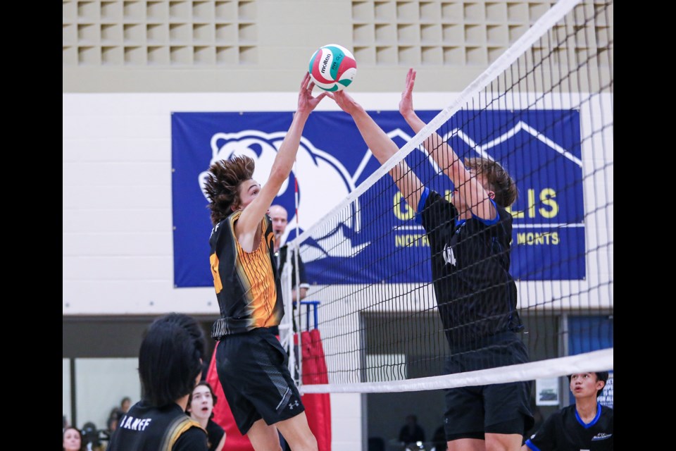 OLS Avalanche Thomas Boruta, right, fends off Banff Bears Macsen Hempstead's smash during the senior South Central Zone boys volleyball tournament at Our Lady of the Snows Catholic Academy in Canmore on Friday (Nov. 17). Banff Bears won the game 2-1. JUNGMIN HAM RMO PHOTO