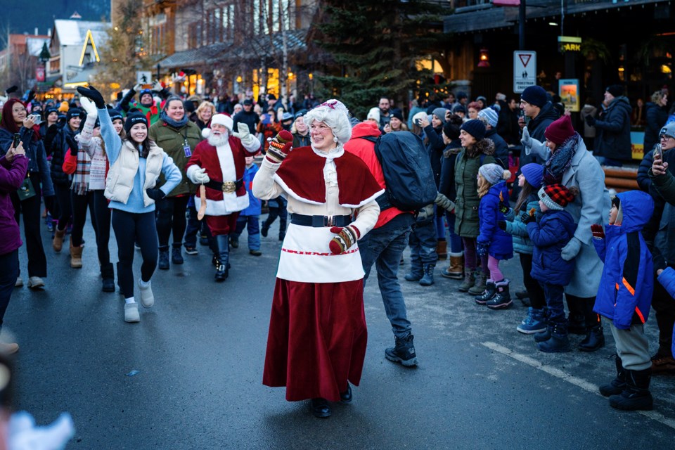 Santa Claus and Mrs. Claus wave to the crowd during the Santa Claus Celebration of Lights at Banff Avenue on Saturday (Nov. 18). BART ONYSZKO RMO PHOTO