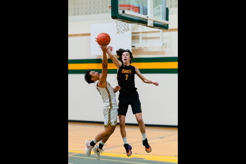 Banff player Finn Mckenna makes the block at the Rocky Mountain Classic Basketball Tournament at Canmore Collegiate High School on Friday (Dec. 1). BART ONYSZKO RMO PHOTO
