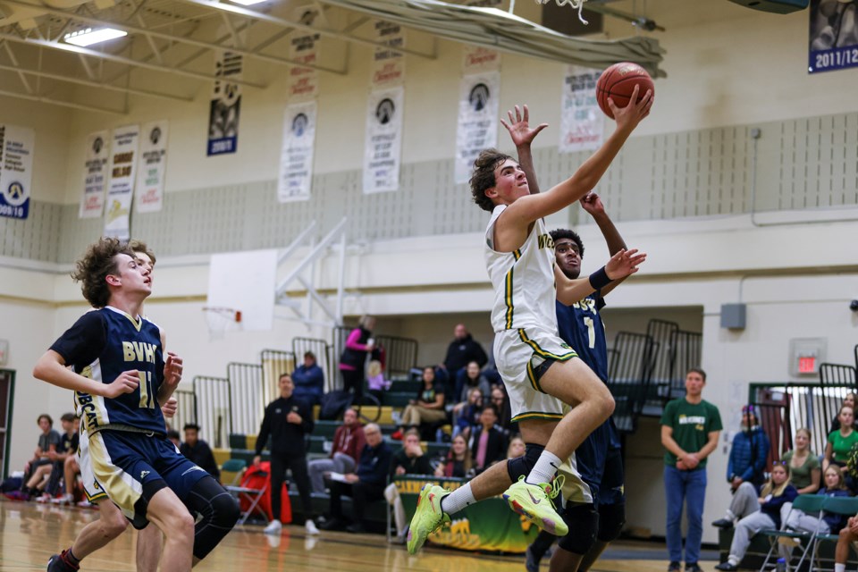 Canmore Wolverines Bekkett Roste goes for a lay-up against the Bow Valley High School Bobcats during the Rocky Mountain Classic JV boys basketball game at Canmore Collegiate High School on Friday (Dec. 15). The Wolverines beat the Bobcats 59-57. JUNGMIN HAM RMO PHOTO 