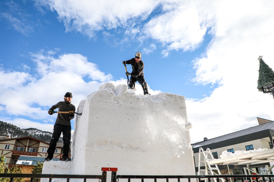 Brothers Joshua Lesage, left, and Jocelyn Lesage from Yukon carve a giant snow sculpture for the SnowDays Winter Festival at Bear Street in Banff in January 2023. JUNGMIN HAM RMO PHOTO