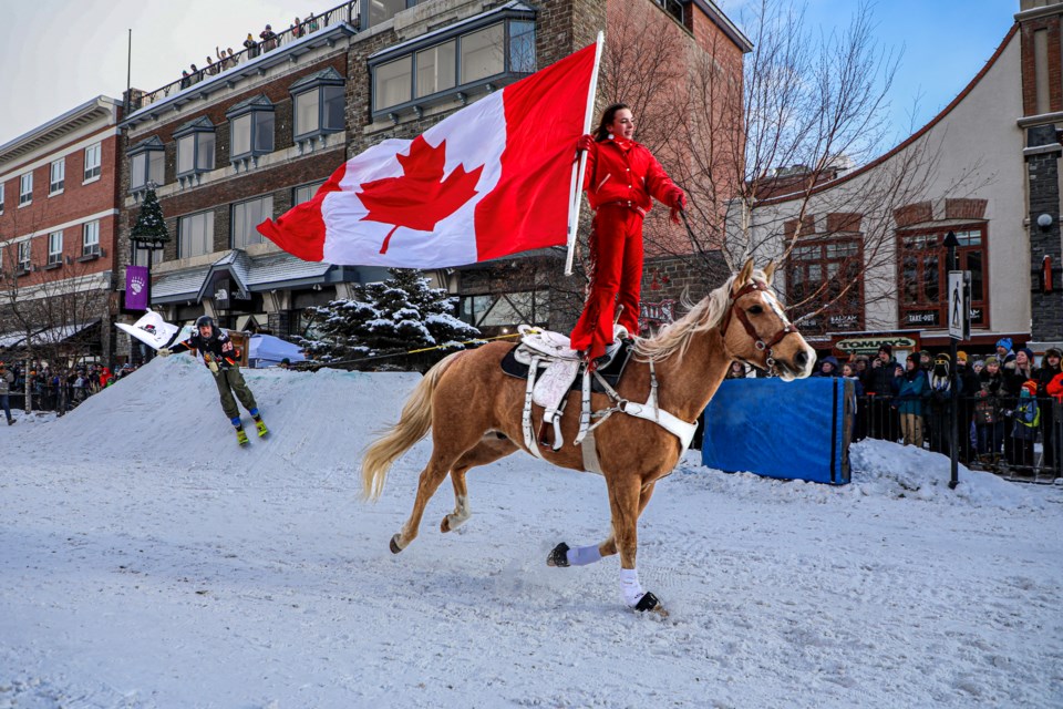 Bella Da Costa rides with a Canadian flag during the Snow Days Skijoring at Banff Avenue in January. JUNGMIN HAM RMO PHOTO