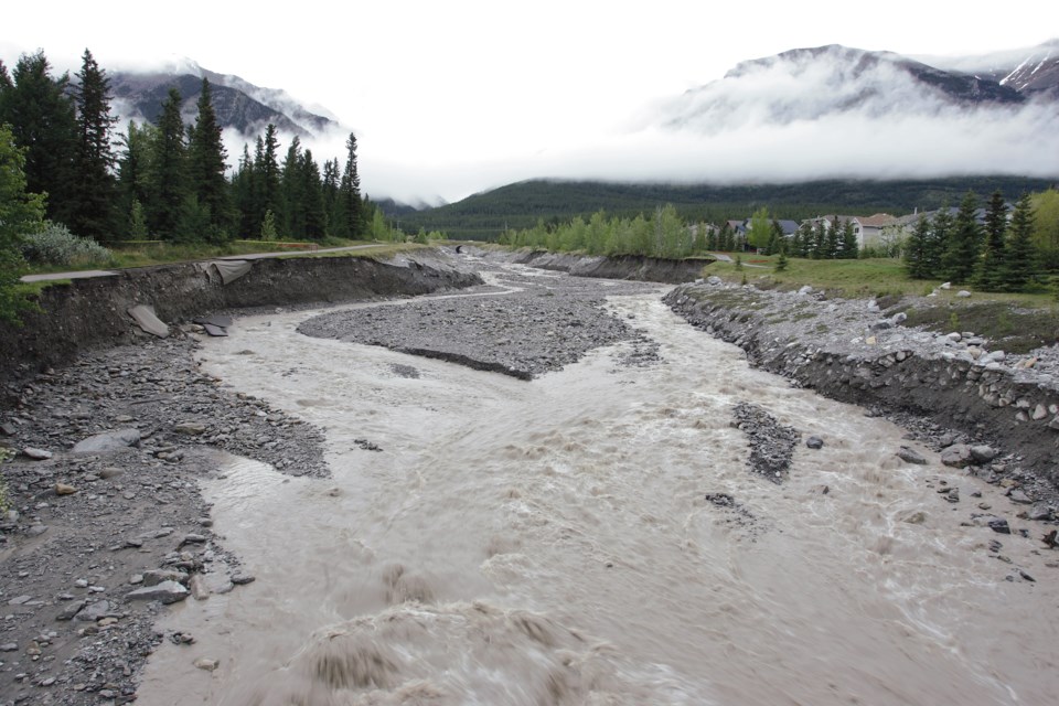 Storm water carves a new path down Cougar Creek in Canmore Wednesday morning (June 6) collapsing sections of the paved path and heavily eroding the banks along the creek. RMO FILE PHOTO                                            